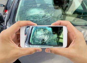 mobile phone photo of a broken windshield