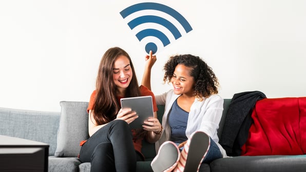 two young ladies sharing wifi