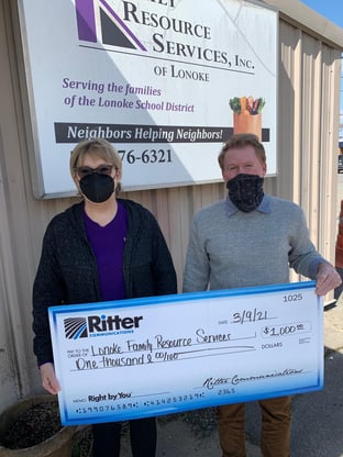Jane Fowler (left) from Family Resource Services, Inc. in Lonoke accepts a $1,000 donation from Ritter Communications Sales Representative Scott Pratt (right).